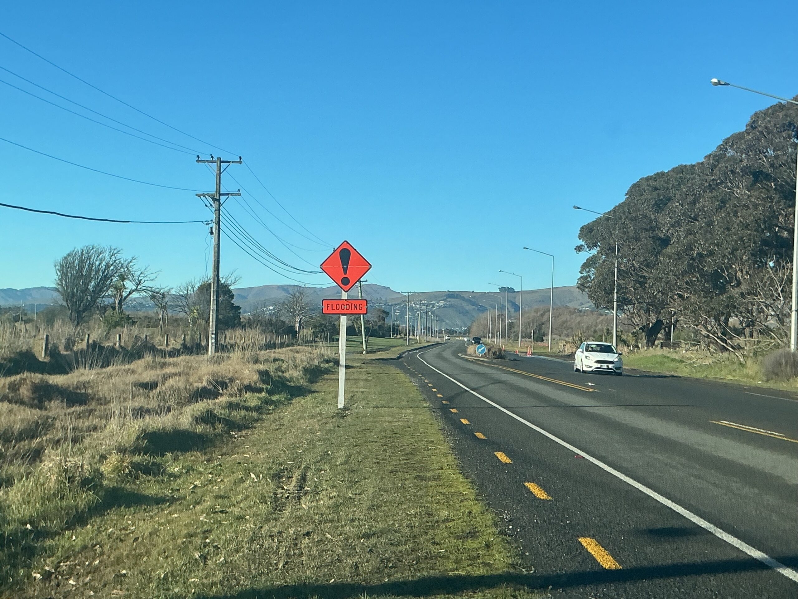New Anzac Drive flood signs flipped into action days after installation